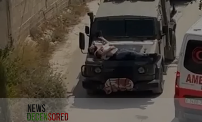 Image of a Palestinian strapped to Israeli vehicle sparks outrage.